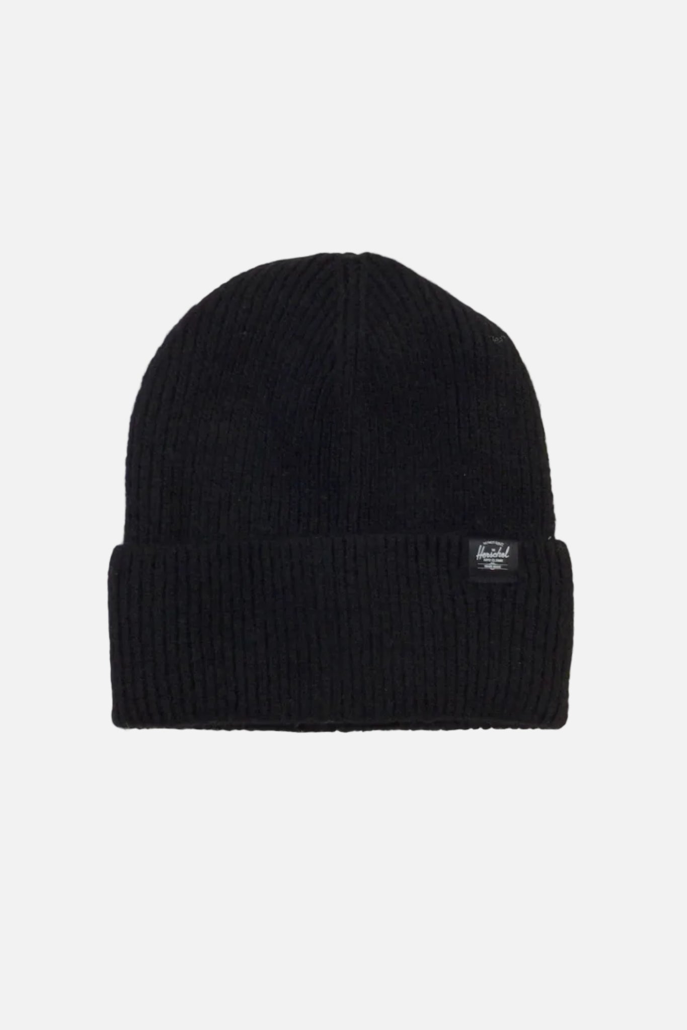 A black ribbed knit beanie hat with a folded cuff, featuring a small white embroidered logo patch on the side, set against a plain off-white background.