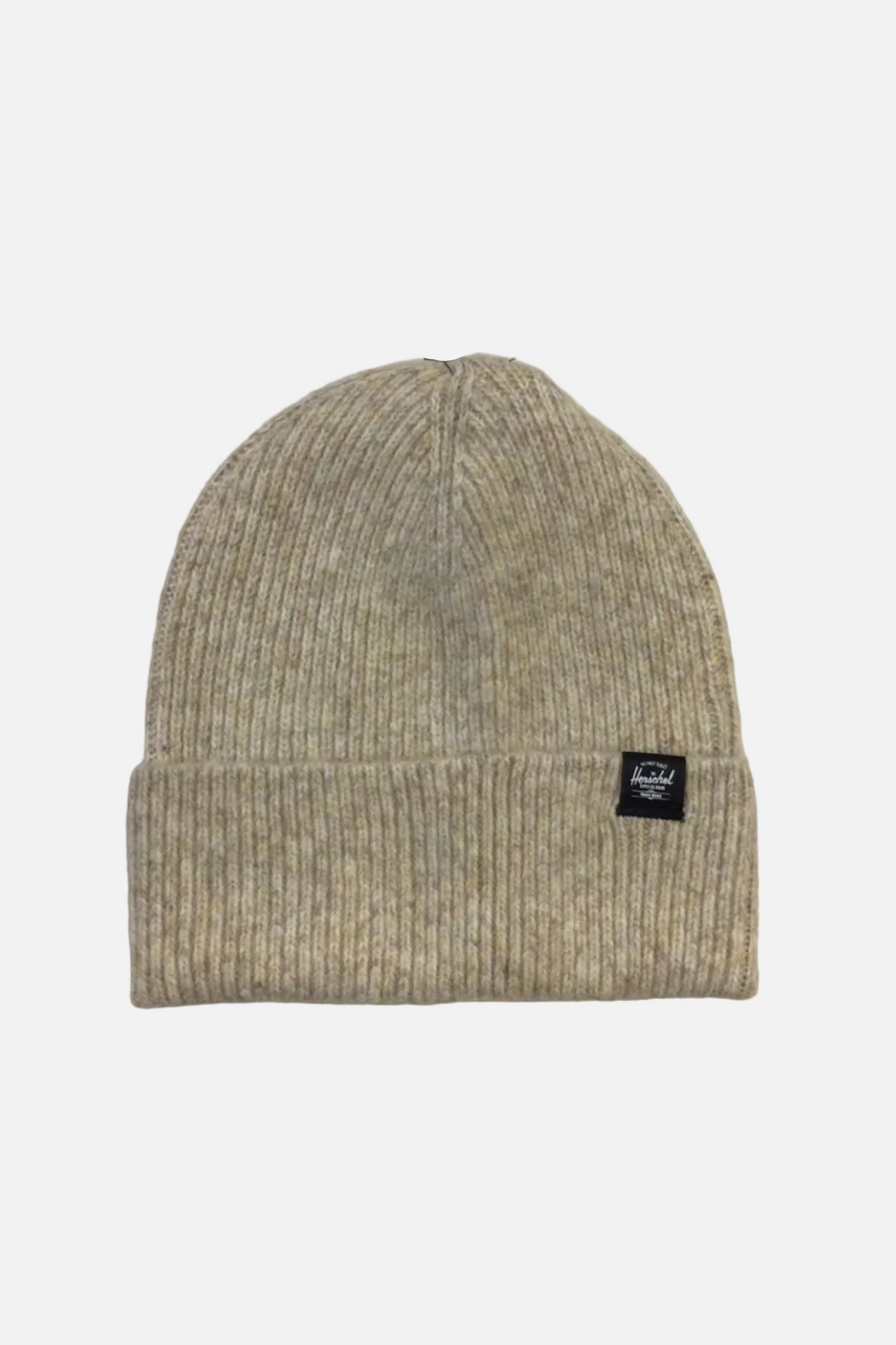 A light beige ribbed knit beanie hat with a small black brand patch on the front cuff, photographed against a plain off-white background.